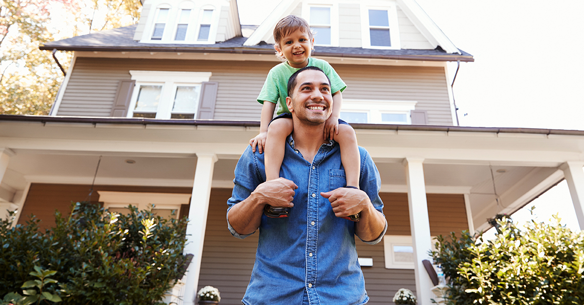 father and son walking away from house