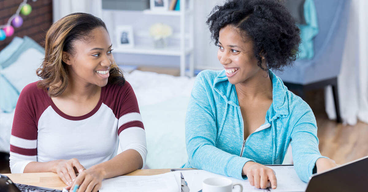 two younger women using laptops to learn about cds