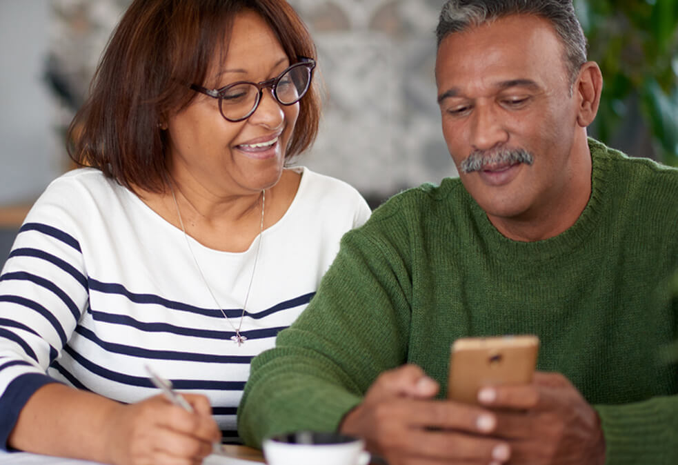 Older couple reviewing bank account on mobile banking app