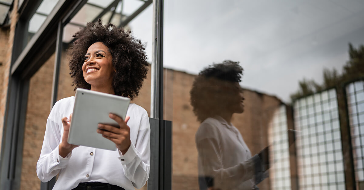 business woman using tablet outside of office